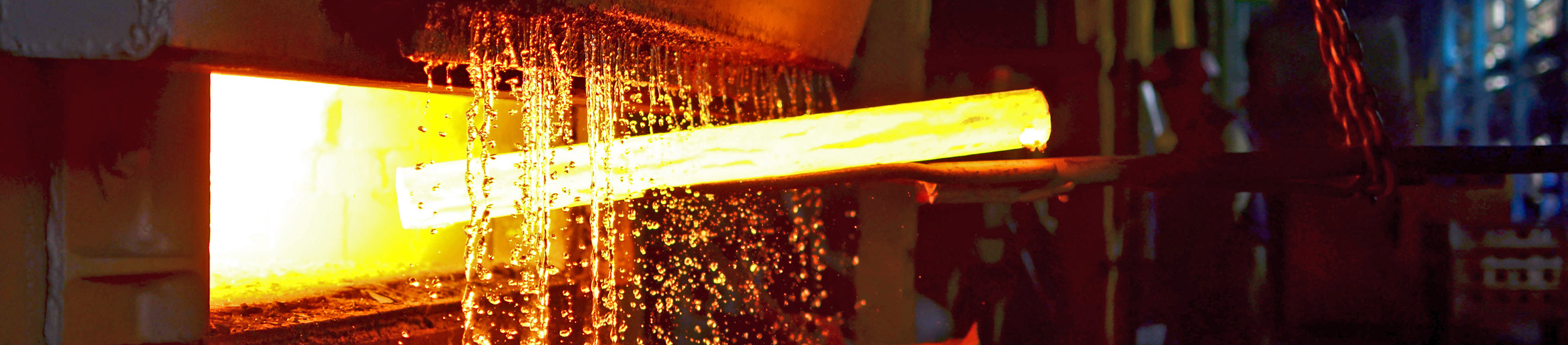 White-hot steel being formed in an industrial setting.